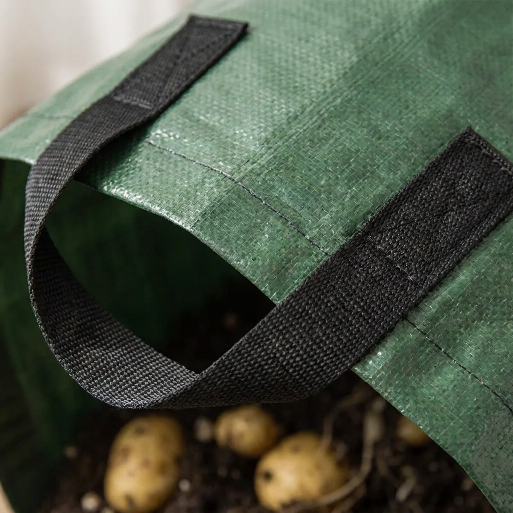 Close-up of breathable PE grow bag fabric and reinforced handles